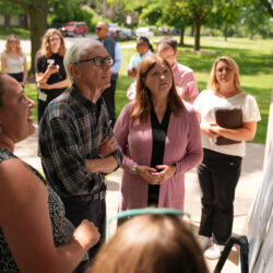Governor Tony Evers looks at a map of the East River watershed at Van Beaver Park in Green Bay, Wis. on July 16, 2024