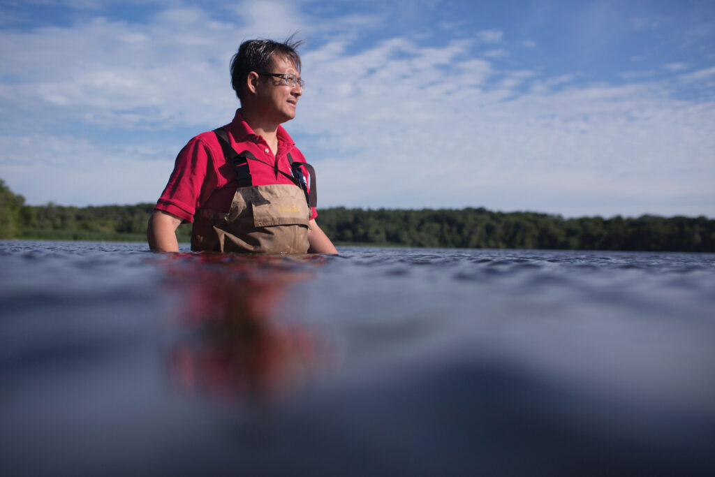 A man wearing waders in a body of water