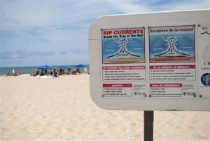 Beach sign warning about rip currents