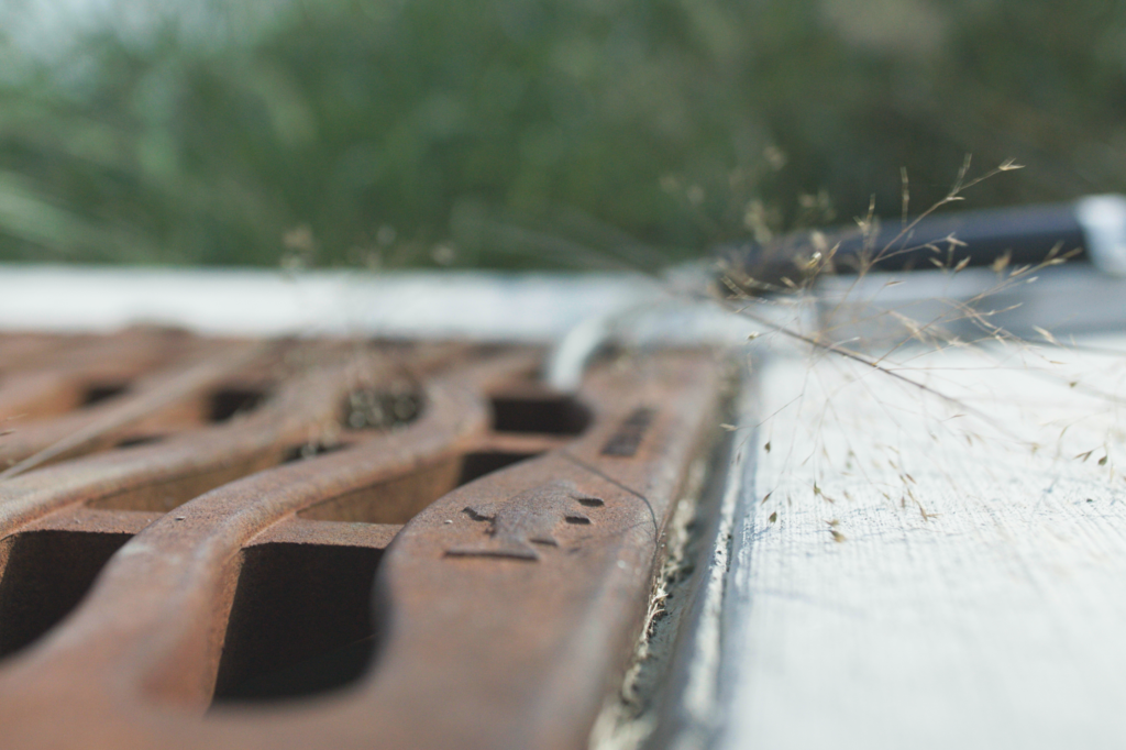 A metal storm drain is ready to capture runoff from the adjacent concrete.